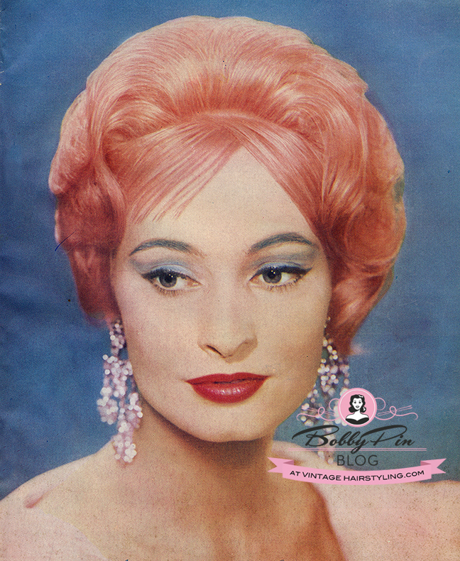 1960 woman with pink hair blue eyeshadow and red lips