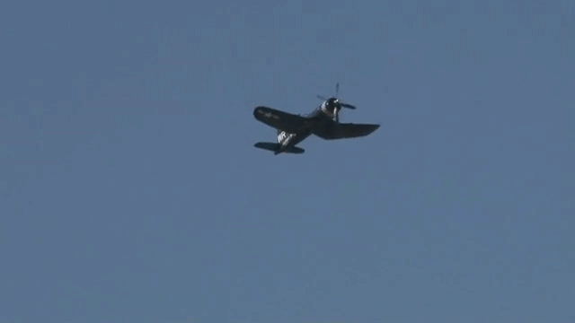 WWII airplane performing victory roll maneuver