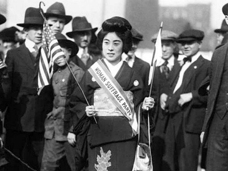 Suffragist Komako Kimura standing in front of men to protest for the right to vote