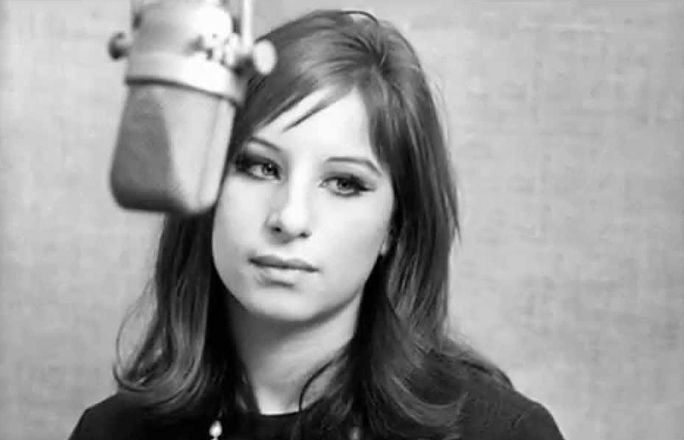 Barbra Streisand  in the early 1960s in a music studio with a microphone