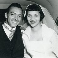 1950s african american black bride with cap wedding veil and groom sitting in back of car