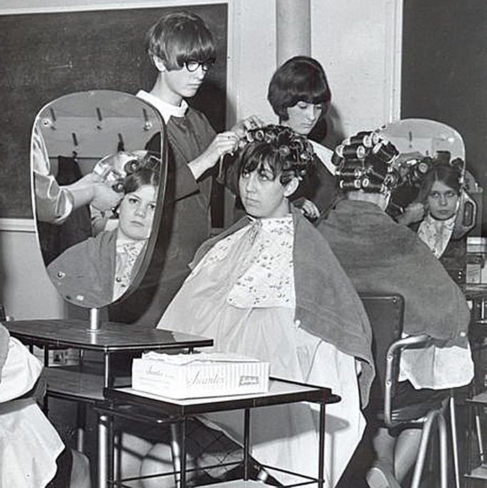 welcome to bobby pin blog feature image women at beauty school setting hair rollers